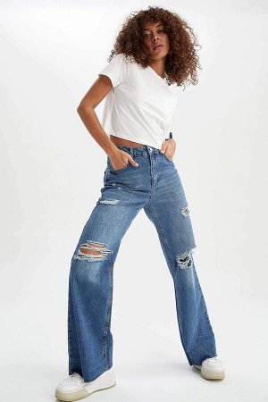 Джинсы Стильные и удобные женские джинсы с дырками на коленях - настоящий тренд сезона. Эта модель на высокой талии со свободной посадкой напоминает знаменитые бойфренды. Такие широкие штаны придают д