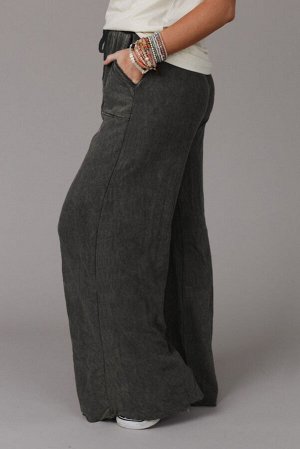 Серые брюки свободного кроя с карманами и завязками