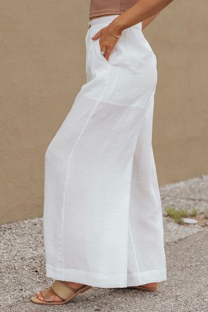 Белые широкие брюки с эластичным поясом и карманами