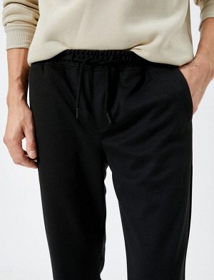 Тканевые брюки с зауженным кроем на кружевной талии и карманами