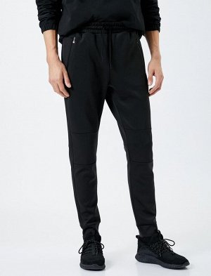 Спортивные брюки-джоггеры с кружевной строчкой на талии и карманом на молнии