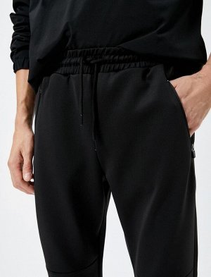 Спортивные брюки-джоггеры с кружевной строчкой на талии и карманом на молнии