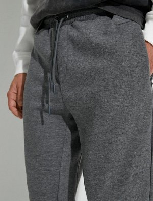 Спортивные брюки-джоггеры с карманом на молнии, шнуровкой на талии и строчкой