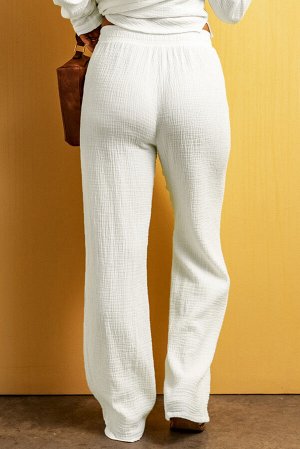Белые брюки свободного кроя из жатой ткани