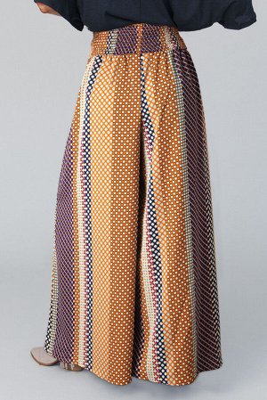 Оранжевые брюки-палаццо с геометрическим принтом