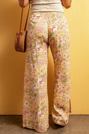 Желтые брюки с цветочным принтом и разрезами