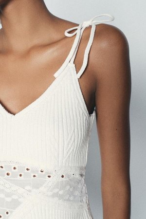 Топ Цвет как на первом фото ТРИКОТАЖНЫЙ ТОП С ВЫШИВКОЙ ГЛАЗ (STRICKTOP MIT LOCHSTICKEREI) Топ с V-образным вырезом на тонких бретелях и бантиках. Комбинация материалов с вышивкой петель. СОСТАВ МАТЕРИ
