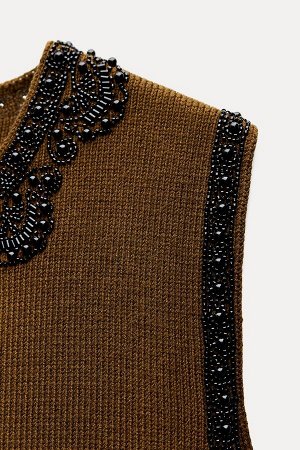 Топ Цвет как на первом фото ВЯЗАННЫЙ ЖИЛЕТ С ДЕКОРАТИВНЫМИ БИСЕРАМИ (STRICKWESTE MIT SCHMUCKPERLEN) Открытый жилет с круглым вырезом и без рукавов. Аппликация бахромой и декоративными бусинами. СОСТАВ