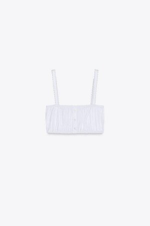 топ ЦВЕТ как на первом фото Укороченный топ из поплина (CROP-TOP AUS POPELIN) Короткий топ с прямым вырезом и узкими бретелями с кружевными краями. Декоративные складки и пуговицы спереди. СОСТАВ МАТЕ