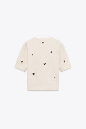 топ ЦВЕТ как на первом фото ВЯЗАНЫЙ ТОП С БУСИНАМИ (STRICKTOP MIT SCHMUCKPERLEN) Топ с круглым вырезом и короткими рукавами. Декоративная аппликация из бисера. СОСТАВ МАТЕРИАЛА, ИНСТРУКЦИИ ПО УХОДУ И 