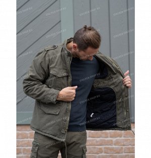 Куртка M65 Классическая куртка в стиле милитари модели M65 с утеплителем из синтетического полифилла. Застегивается на молнию, прикрытую клапаном на кнопках. Капюшон куртки сворачивается и прячется в 