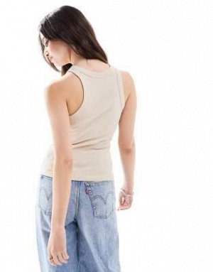 Топ Майка-борцовка Monki в рубчик бежевого цвета (Monki – Geripptes Tr?gertop in Beige mit Ringerr?cken) Топы от Monki * Простой дизайн * Круглый вырез * Спинка-борцовка * Облегающий крой Код товара: 
