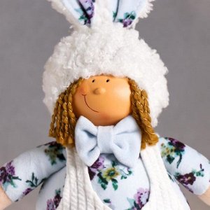 Кукла интерьерная "Малыш в белом комбезе и цветочной рубашке, в шапке-зайки" 43х11х17 см
