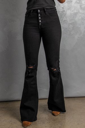Черные джинсы-клеш с застежкой на пуговицах и дырками на коленях