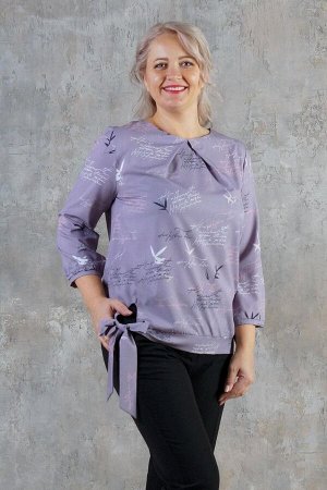 Блуза Очаровательная блуза выполнена из эластичной блузочной ткани. Расцветка цветы на фиолетовом. Вырез горловины круглый с встречной складкой. Рукав 3/4 49 см. на манжете. Низ на завязке. Без застёж